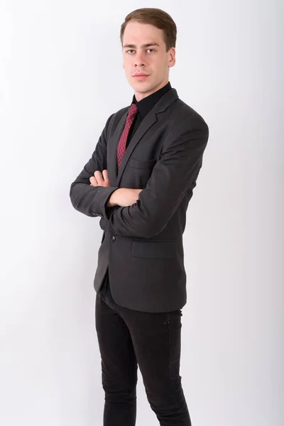 Joven hombre de negocios guapo usando traje contra fondo blanco — Foto de Stock