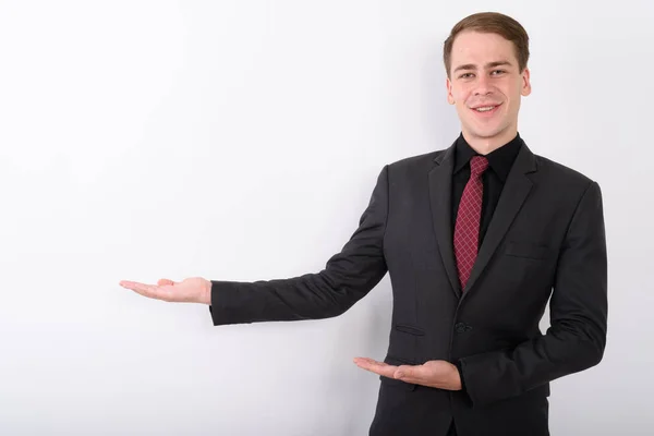 Young handsome businessman wearing suit against white background — Stock Photo, Image