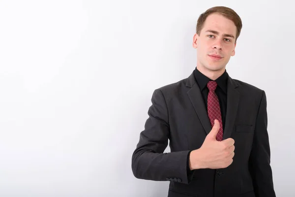 Young handsome businessman wearing suit against white background — Stock Photo, Image