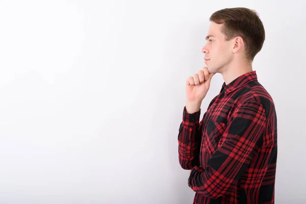 Young handsome man wearing red checkered shirt against white bac — Stock Photo, Image