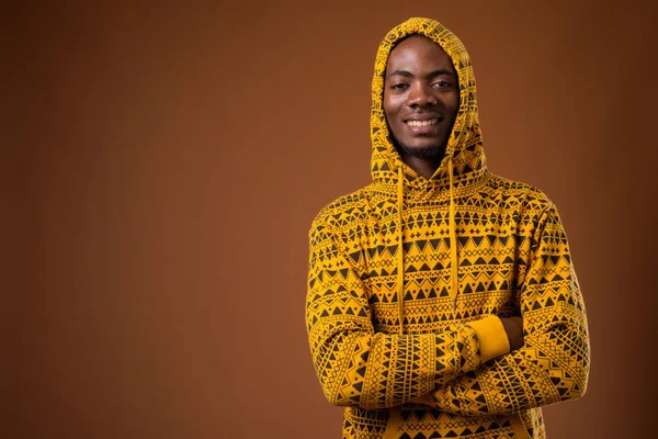 Fiatal csinos afrikai férfi barna háttér — Stock Fotó