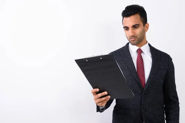 Young handsome Indian businessman against white background — Stock Photo, Image