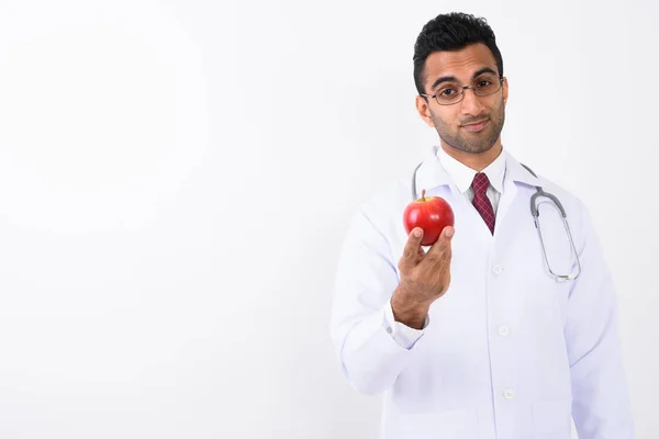 Young handsome Indian man doctor against white background — Stock Photo, Image