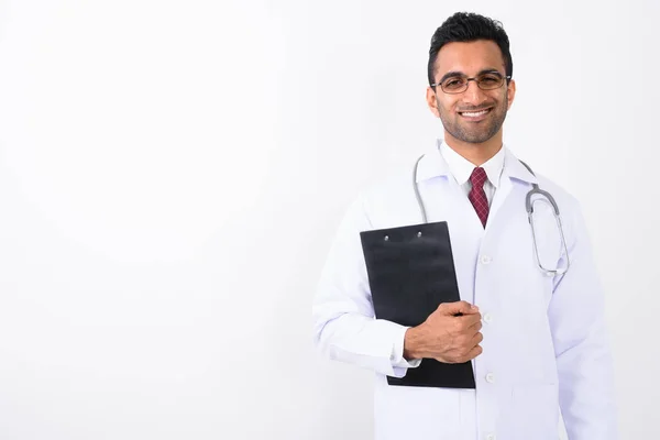 Young handsome Indian man doctor against white background Stock Image