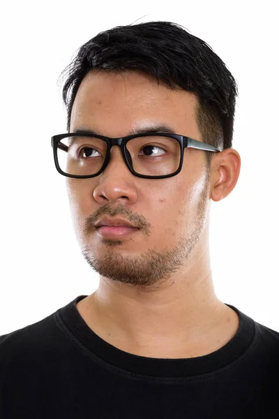 Face of young Asian man thinking while looking at distance and w — Stock Photo, Image