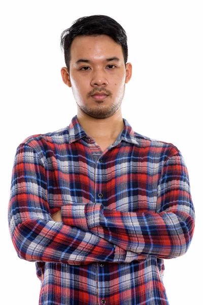 Studio shot of young Asian man with arms crossed — Stock Photo, Image