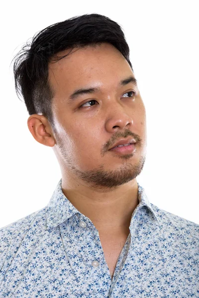 Face of young Asian man thinking while looking up — Stock Photo, Image