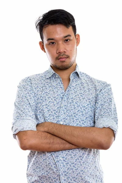 Studio shot of young Asian man with arms crossed — Stock Photo, Image