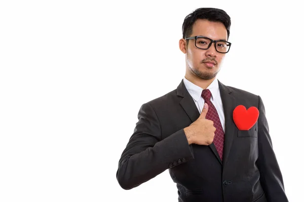 Studioaufnahme eines jungen asiatischen Geschäftsmannes, der den Daumen mit Rot nach oben gibt — Stockfoto