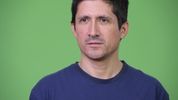 Hombre hispano pensando en fondo verde — Vídeos de Stock