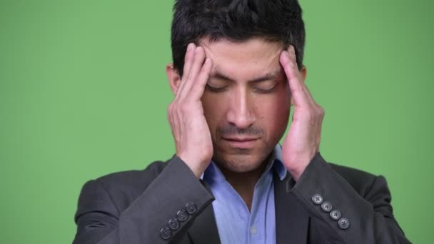 Stressed Hispanic businessman having headache — Stock Video