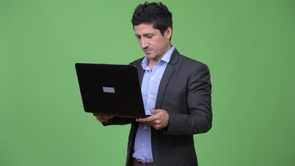 Happy Hispanic businessman using laptop — Stock Video