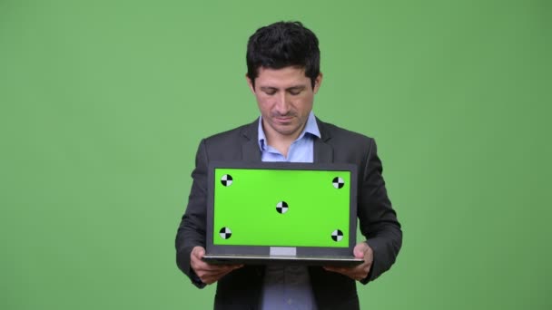 Happy Hispanic businessman showing laptop — Stock Video