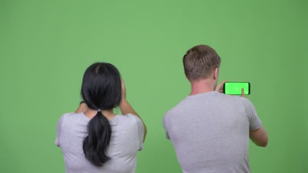 Joven pareja multiétnica fotografiando con el teléfono juntos — Vídeos de Stock