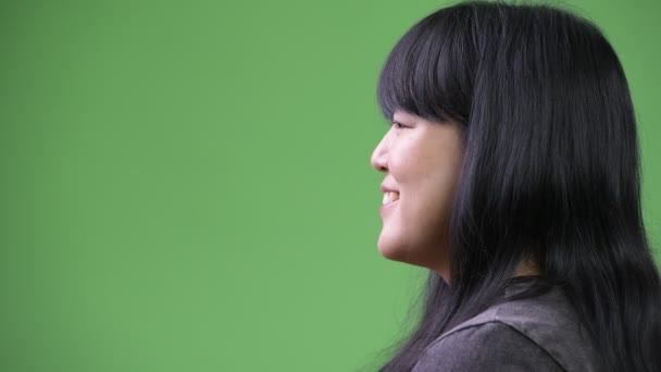 Head shot profile view of beautiful overweight Asian woman smiling — Stock Video