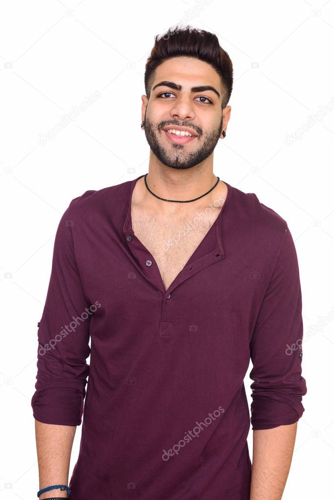 Studio shot of young happy Indian man isolated against white bac