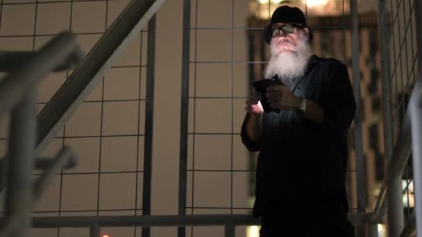 Telefon kullanırken şüpheli görünen olgun sakallı adam — Stok video