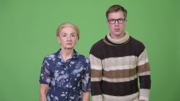 Grandmother and grandson looking away in different directions together — Stock Video