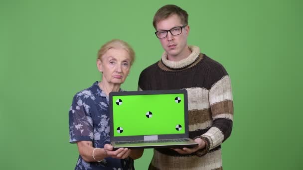 Šťastná babička a vnuk ukazuje notebook dohromady — Stock video
