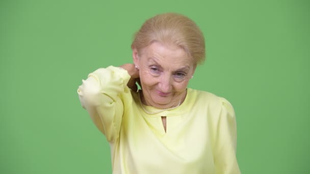 Stressed senior businesswoman having neck pain — Stock Video