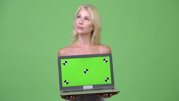 Unga glada vacker affärskvinna tänkande samtidigt visar laptop — Stockvideo