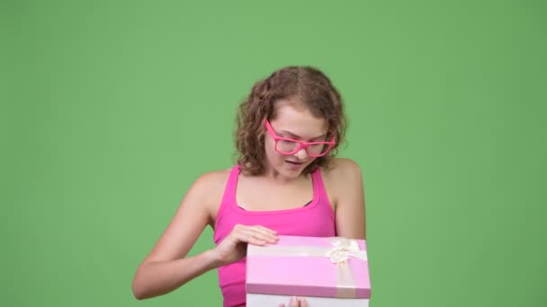 Jeune heureuse belle femme nerd ouverture boîte cadeau et l'air surpris — Video