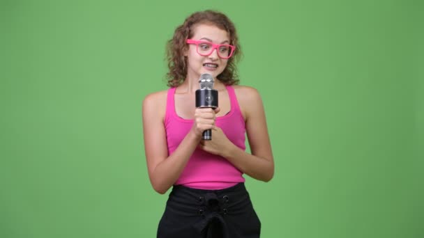 Young anxious nerd woman presenting something while looking nervous — Stock Video