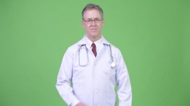 Silah ile gözlük takıyor olgun adam doktor portresi geçti