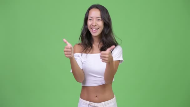 Young happy beautiful multi-ethnic woman looking excited while giving thumbs up — Stock Video