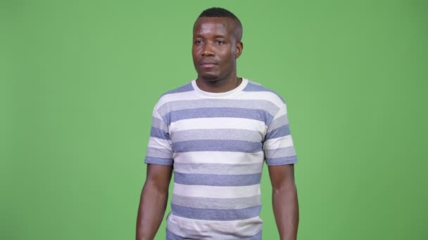 Joven hombre africano feliz mirando emocionado y dando pulgares hacia arriba — Vídeo de stock