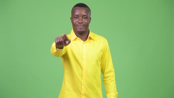 Joven empresario africano feliz señalando a la cámara — Vídeo de stock