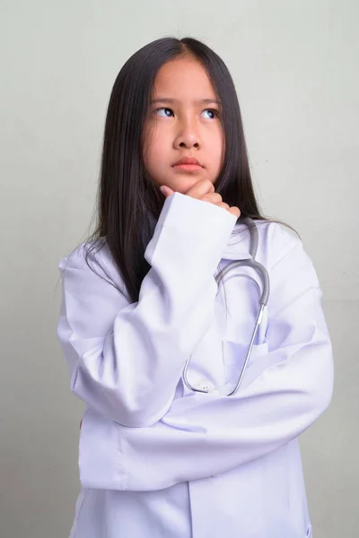 Portrait of young cute Asian girl as doctor