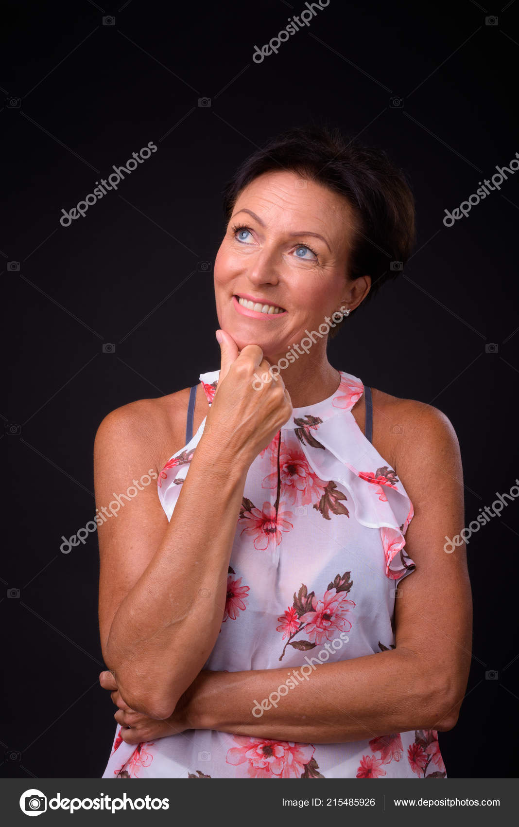 Mature Beautiful Woman With Short Hair Against Black Background
