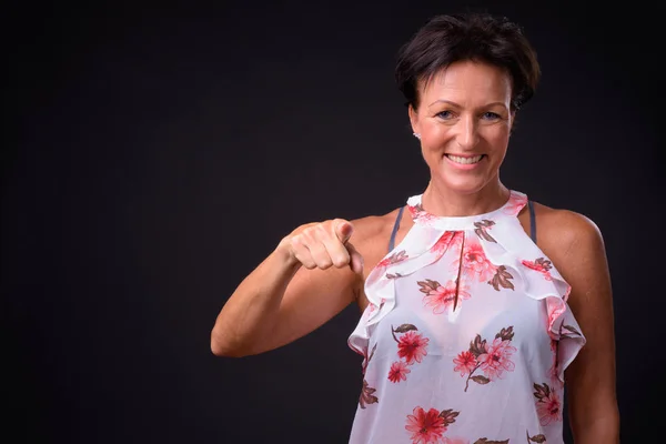 Mature beautiful woman with short hair against black background — Stock Photo, Image