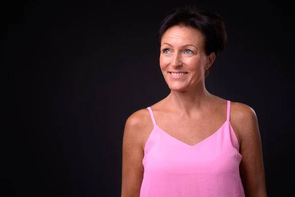 Mature beautiful woman with short hair against black background — Stock Photo, Image