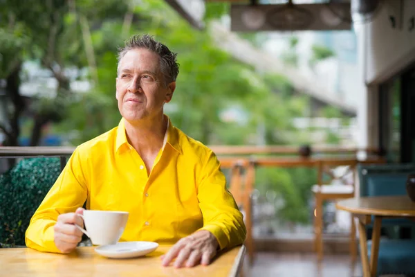 Mature Handsome Man Sitting In Coffee Shop And Thinking — Stock Photo, Image