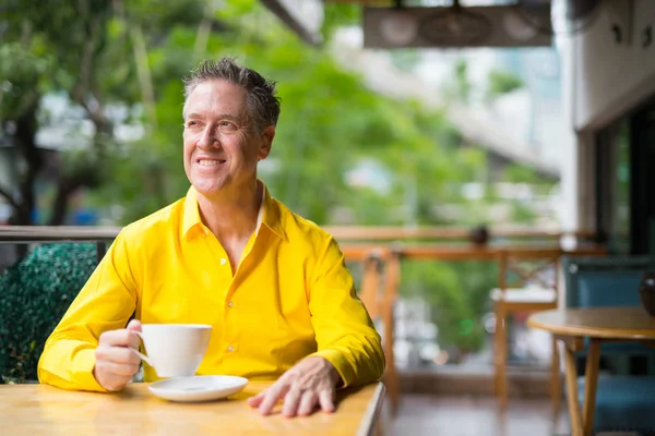 Happy Mature Man Sitting In Coffee Shop And Thinking — Stock Photo, Image
