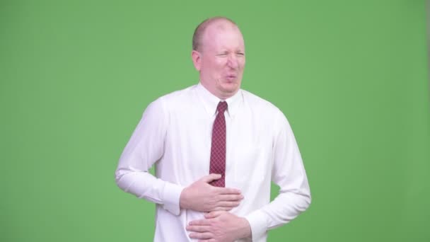 Stressed mature bald businessman having stomach ache — Stock Video