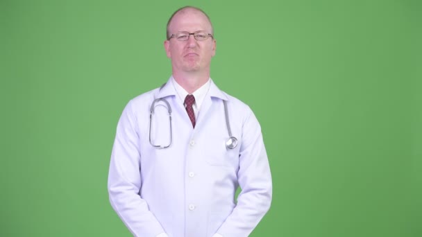 Mature bald man doctor showing stop gesture with both arms — Stock Video