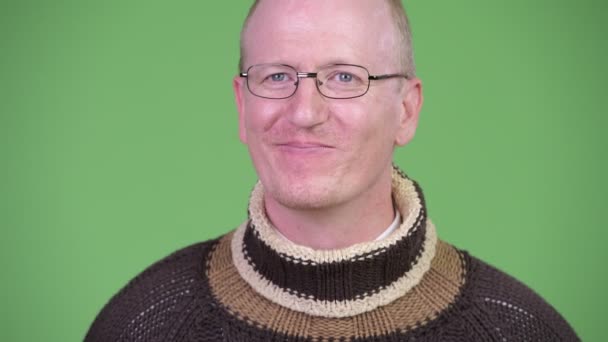 Happy mature bald man with turtleneck sweater thinking — Stock Video