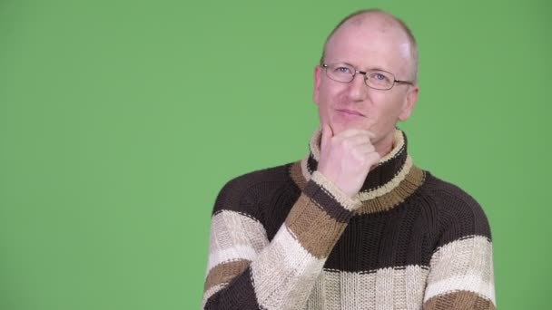 bald man turtleneck