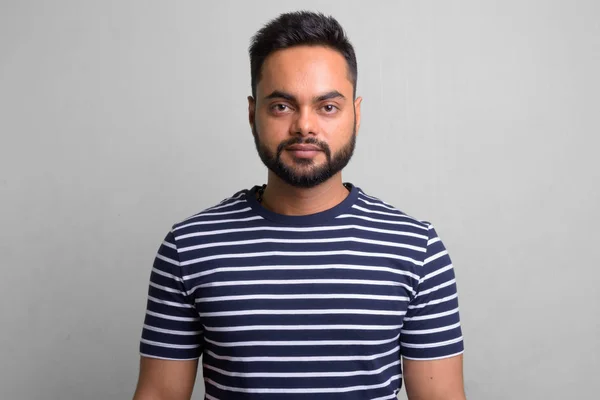 Young bearded Indian man against white background — Stock Photo, Image