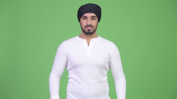 Young handsome bearded Indian man covering ears as three wise monkeys concept — Stock Video