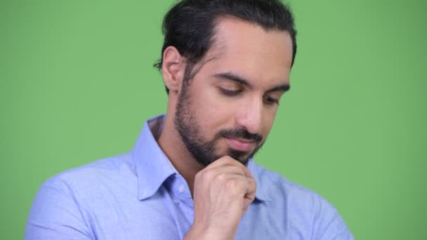 Young serious bearded Indian businessman thinking — Stock Video