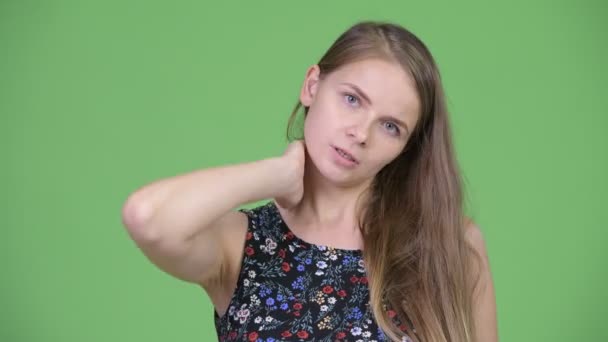 Head shot of young stressed woman having neck pain — Stock Video