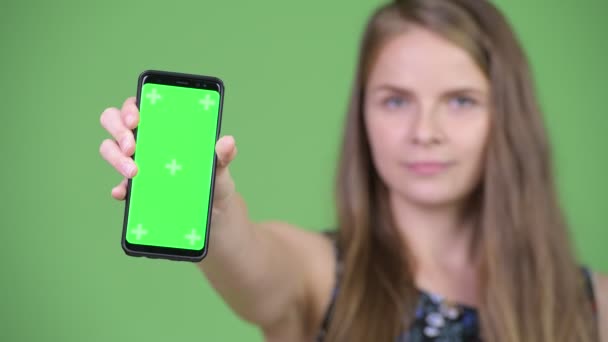 Young happy beautiful woman showing phone — Stock Video