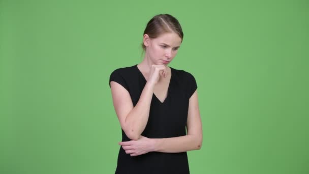 Young serious businesswoman thinking while looking down — Stock Video