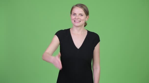 Young happy beautiful businesswoman giving handshake — Stock Video