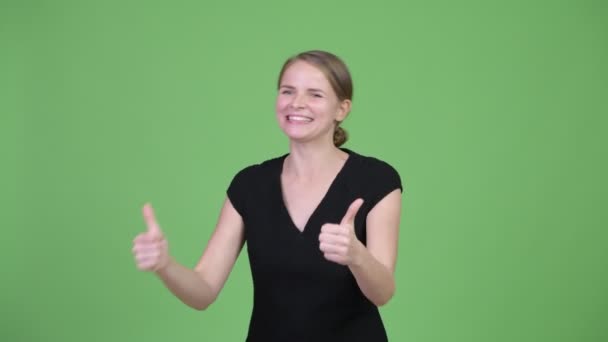 Young happy beautiful businesswoman looking excited and giving thumbs up — Stock Video