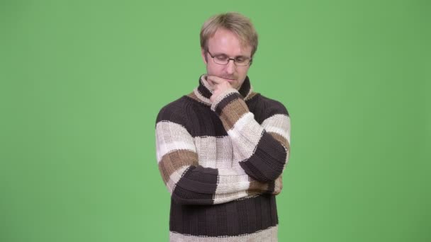 Studio shot of serious man thinking while looking down — Stock Video